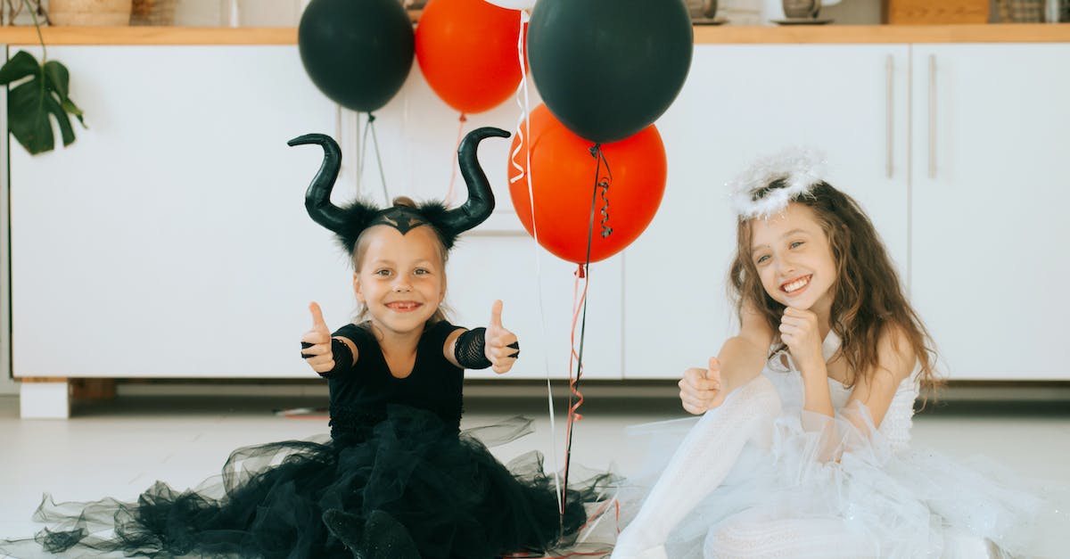 Diablo angel and demon name etymologies - Two Cute Girls in Halloween Costume Sitting on the Floor