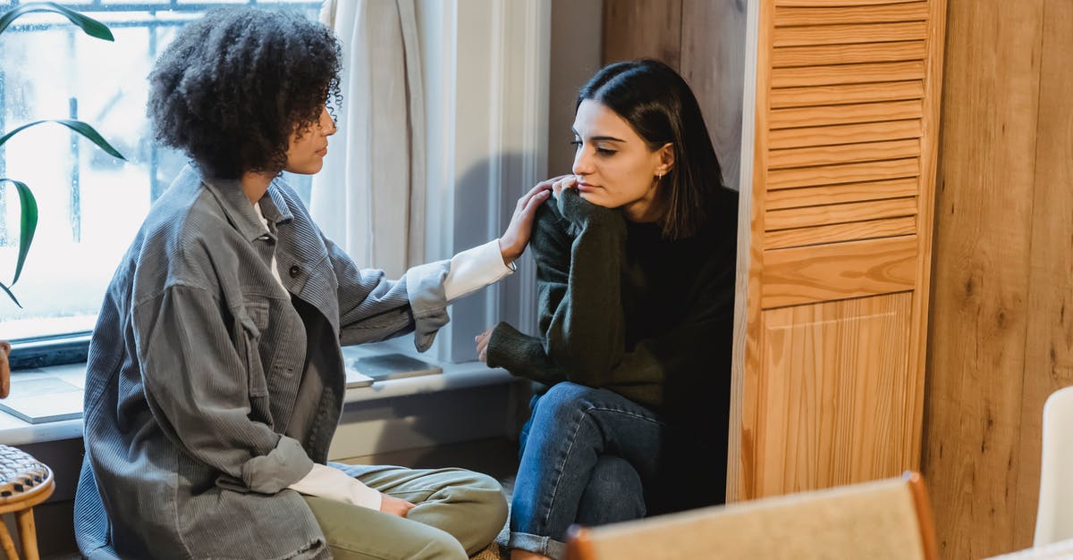 Dialogue help please! - Calm young multiracial female best friends in casual clothes sitting near window and home and discussing discussing problems Dialogue help please! - Calm young multiracial female best friends in casual clothes sitting near window and home and discussing discussing problems