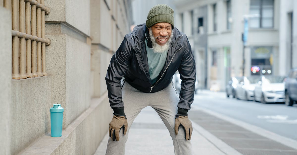 Did Morinth actually think Shepard is strong-willed enough? - Concentrated bearded mature black man in activewear standing on street leaning forward with hands on knee while resting after hard training Did Morinth actually think Shepard is strong-willed enough? - Concentrated bearded mature black man in activewear standing on street leaning forward with hands on knee while resting after hard training