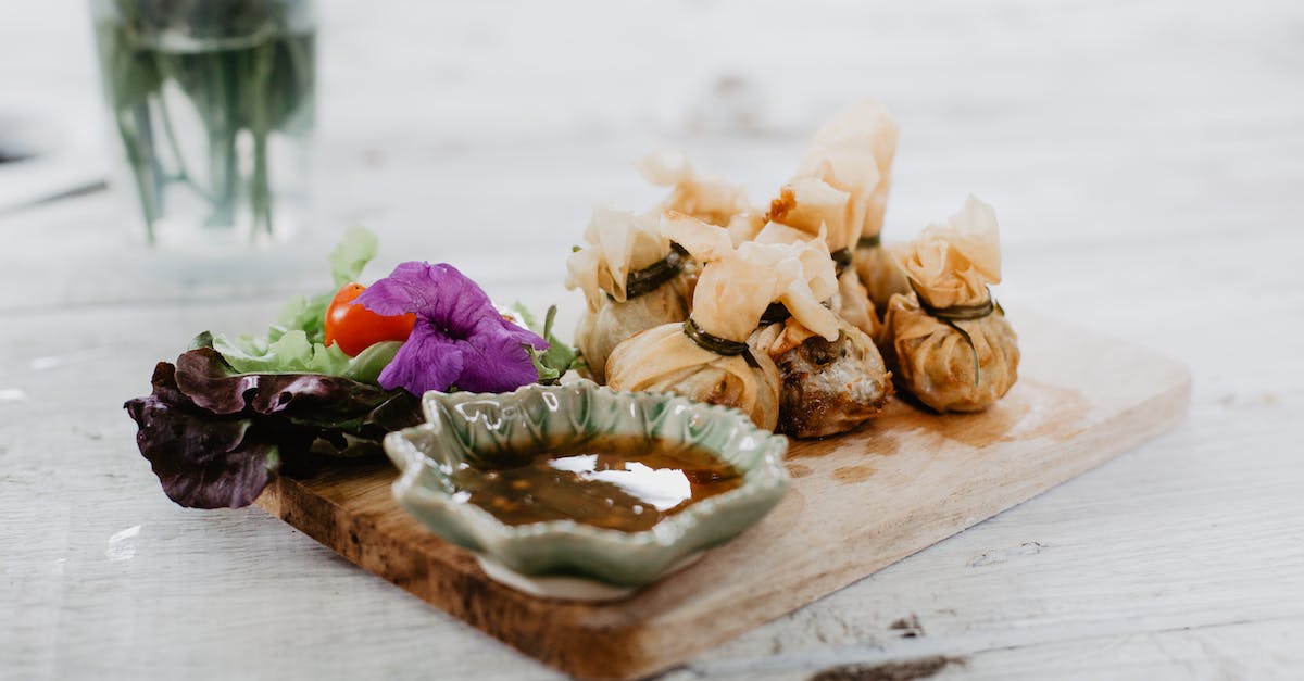 Difference between different ammunition - Dim sum and vegetables on wooden board in cafe