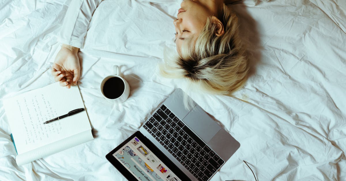 Difference between using a bed or a sleeping bag in Rust? - Student sleeping on bed near laptop and cup of coffee