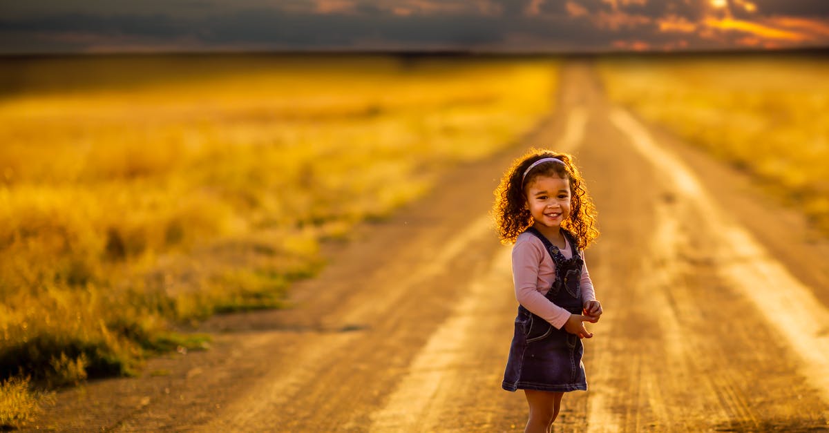 Dirt is turning into grass - Girl Standing in the Middle of the Road Dirt is turning into grass - Girl Standing in the Middle of the Road