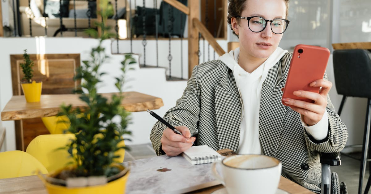 Disable Steam Guard email, but not phone guard? - Focused businesswoman in wheelchair using smartphone in cafe Disable Steam Guard email, but not phone guard? - Focused businesswoman in wheelchair using smartphone in cafe