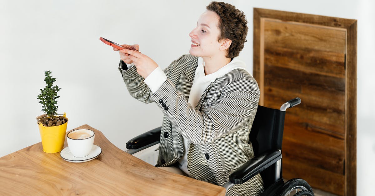 Disable Steam Guard email, but not phone guard? - Positive female in wheelchair taking picture of hot coffee on smartphone while sitting at table with plant in modern cafe Disable Steam Guard email, but not phone guard? - Positive female in wheelchair taking picture of hot coffee on smartphone while sitting at table with plant in modern cafe