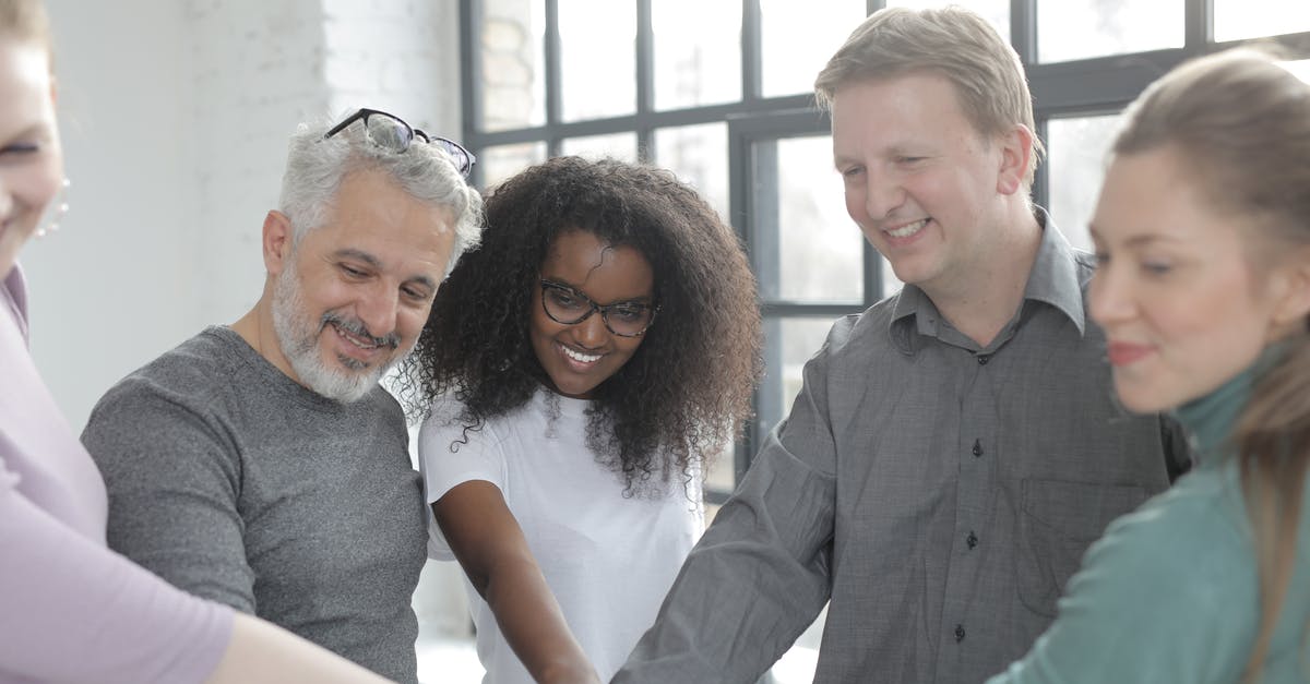 Discord-Minecraft integration - Happy diverse colleagues joining hands at work in afternoon Discord-Minecraft integration - Happy diverse colleagues joining hands at work in afternoon