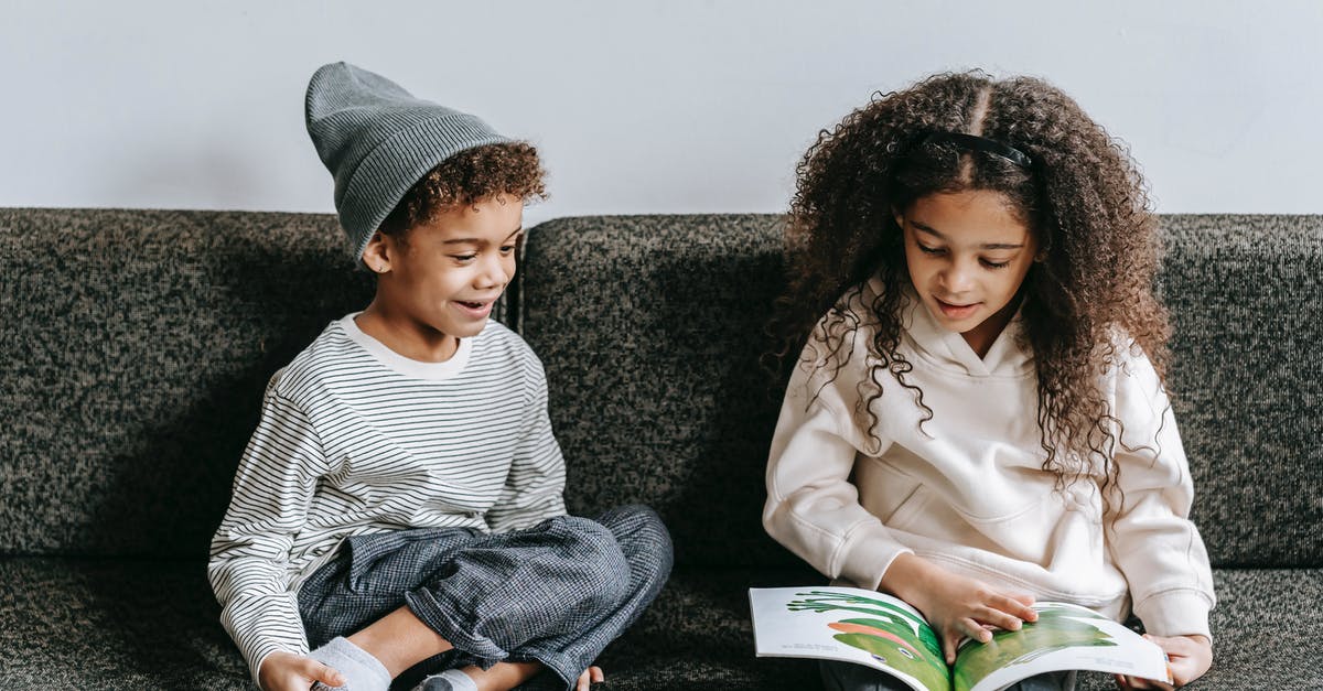 Disney Infinity 2.0 - Where is all the story content? - Delighted ethnic little siblings reading interesting book on couch Disney Infinity 2.0 - Where is all the story content? - Delighted ethnic little siblings reading interesting book on couch