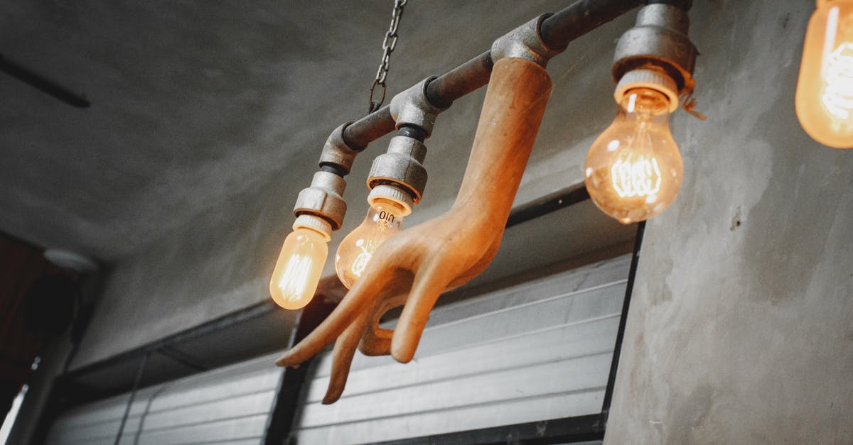 Divinity: Original sin Boreas Treasure room - From below set of light bulbs hanging on metal railing and decorated with creative hand shaped lamp showing mudra