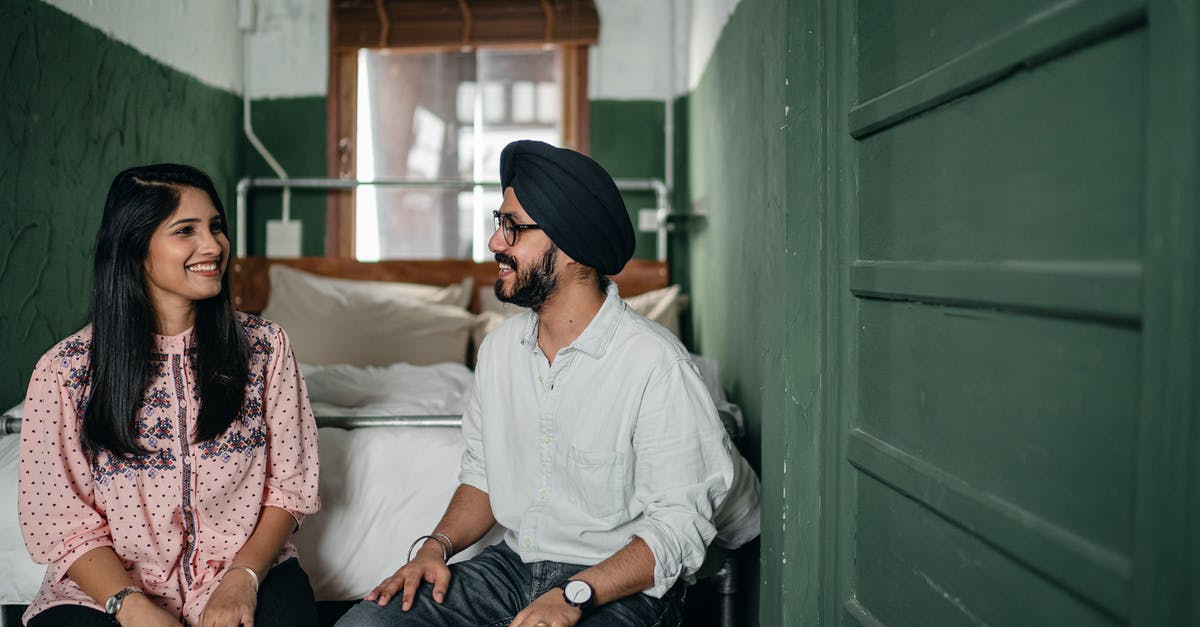 Do any heroes share romantic relationships with other heroes? - Smiling Indian couple in casual clothes and turban sitting on bench against bed in narrow green bedroom and chatting while looking at each other happily Do any heroes share romantic relationships with other heroes? - Smiling Indian couple in casual clothes and turban sitting on bench against bed in narrow green bedroom and chatting while looking at each other happily