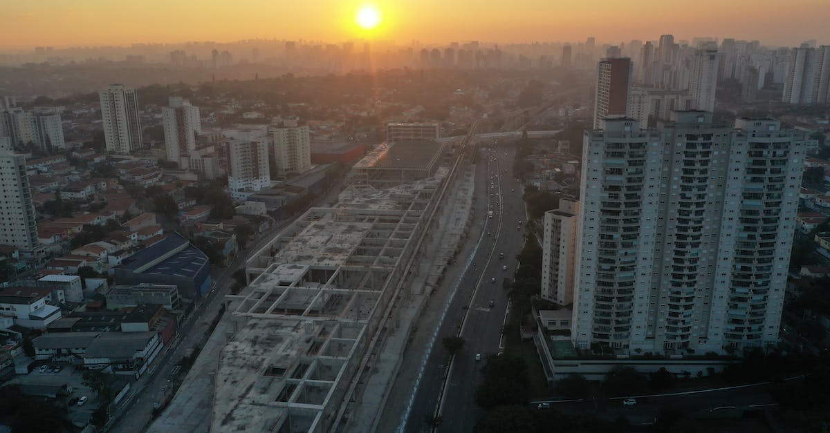 Do auto attack blocks/dodges block empowered auto attacks? - Drone view of concrete beams of building under construction located along road with cars in town at sunset
