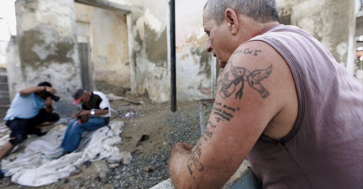 Do bosses take damage during transformation animations? - Tattooed man contemplating unrecognizable ethnic partner with cat near photographer Do bosses take damage during transformation animations? - Tattooed man contemplating unrecognizable ethnic partner with cat near photographer