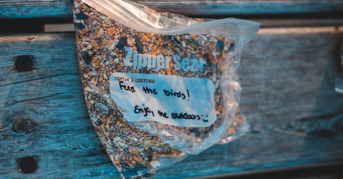 Do citizens want different kind of parks? - From above of transparent plastic zipper bag with bird feed and titles on wooden plank Do citizens want different kind of parks? - From above of transparent plastic zipper bag with bird feed and titles on wooden plank