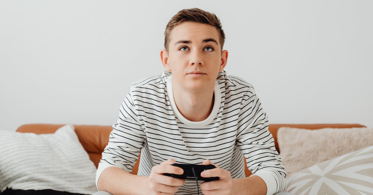 Do console cheats disable achievements? [duplicate] - Teenage Boy Sitting on a Couch and Playing Video Games 