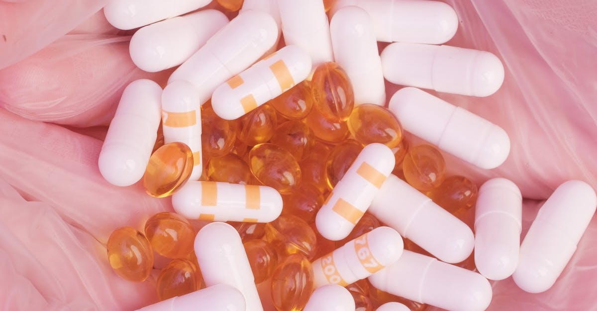 Do different foods heal different amounts of HP? - Top view unrecognizable person in sterile gloves showing heap of assorted drugs and vitamin capsules