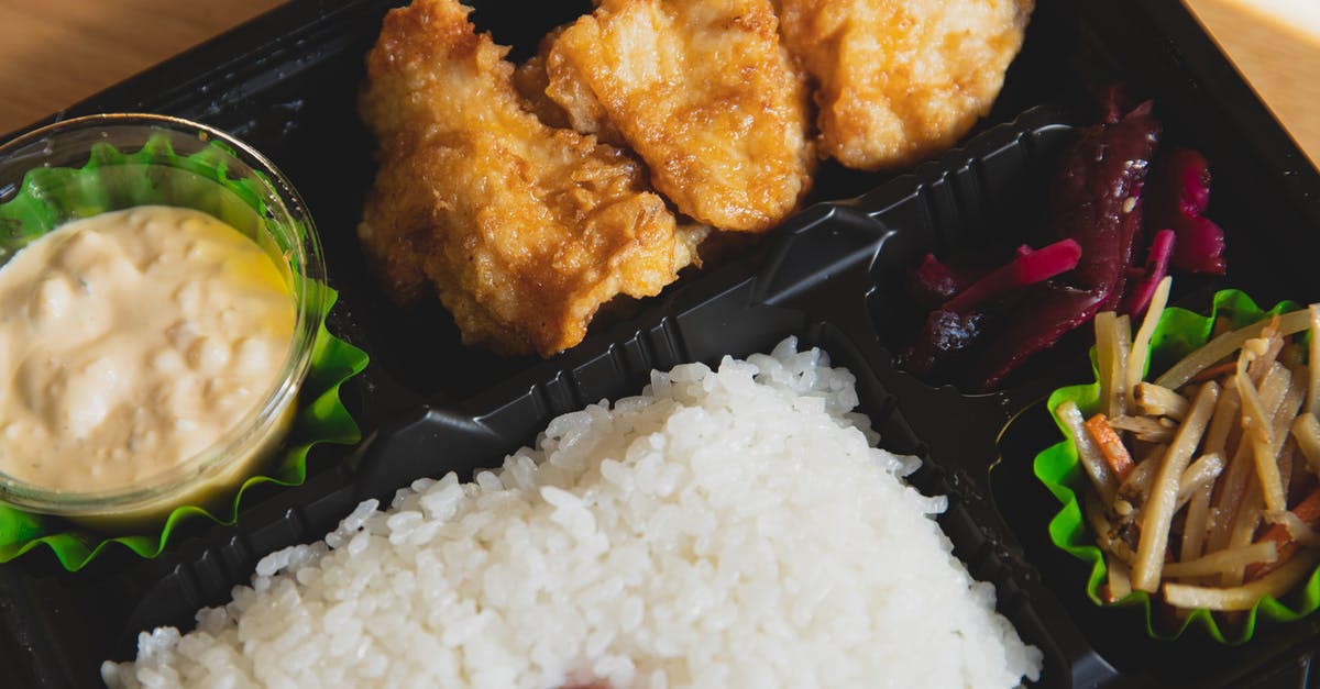 Do different types of meat fill more hunger bars? - From above of plastic container with fried chicken and rice with sauce near sauce and sliced vegetables