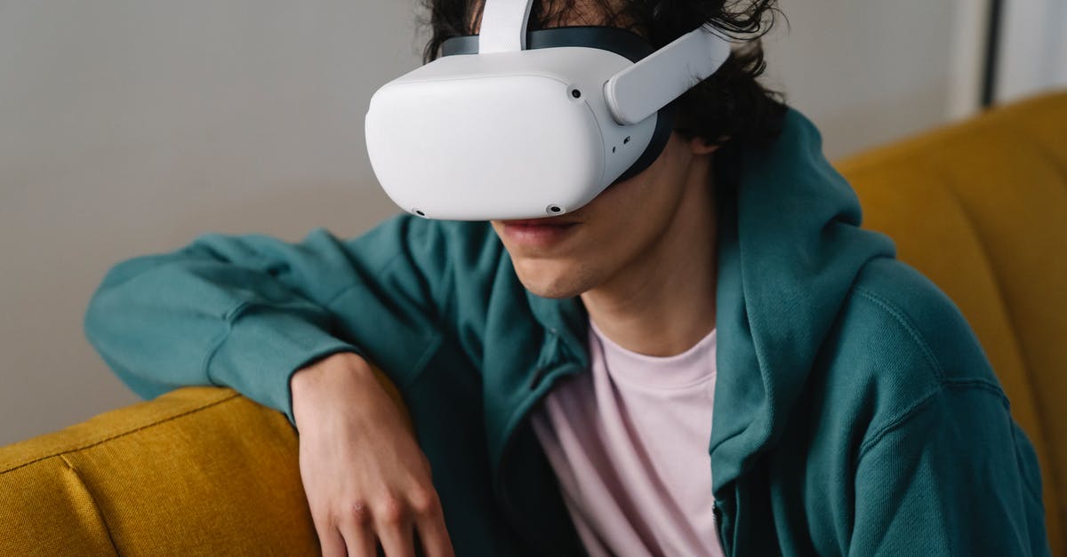 Do dinos gain experience from harvesting? - High angle of young male sitting on couch and exploring futuristic virtual reality in modern goggles