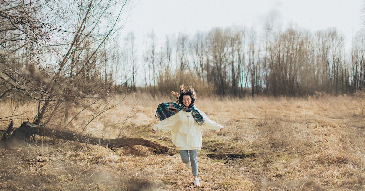 Do DS cartridge batteries run dry? - Full body of cheerful young female in warm clothes with hands outstretched running along dry grass Do DS cartridge batteries run dry? - Full body of cheerful young female in warm clothes with hands outstretched running along dry grass