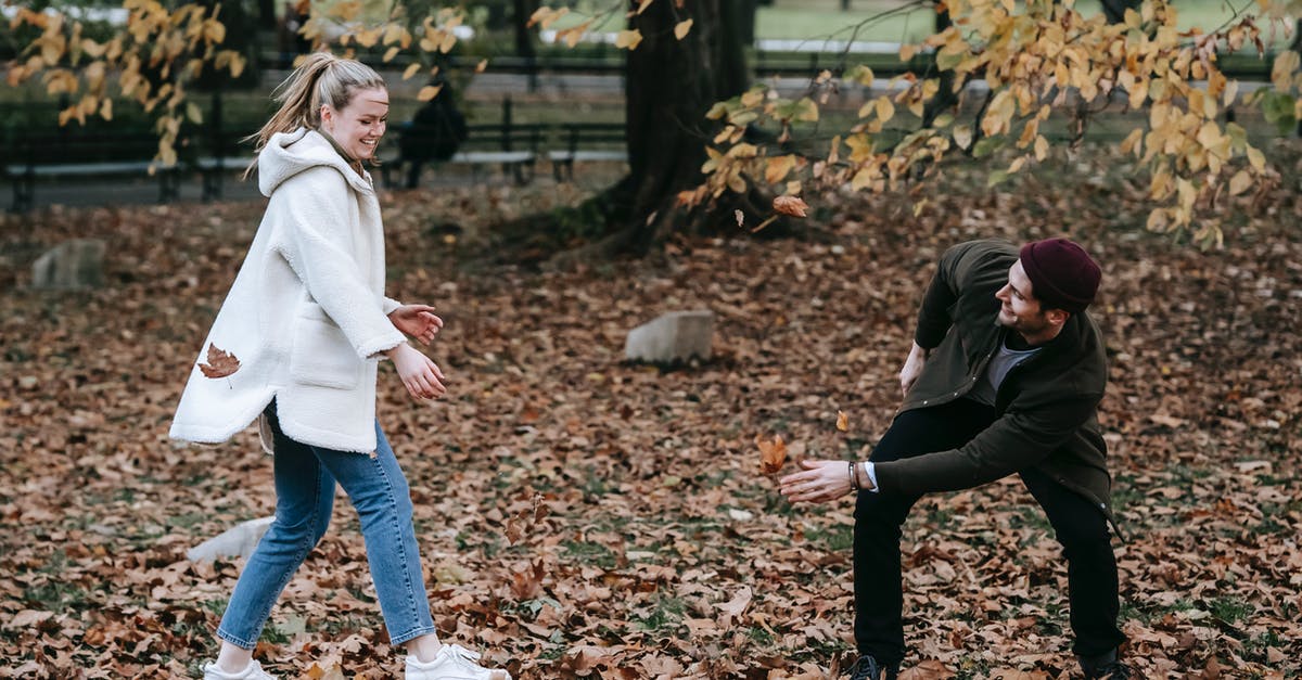 Do expeditions have an expiration date? - Cheerful young couple playing with fallen leaves in park