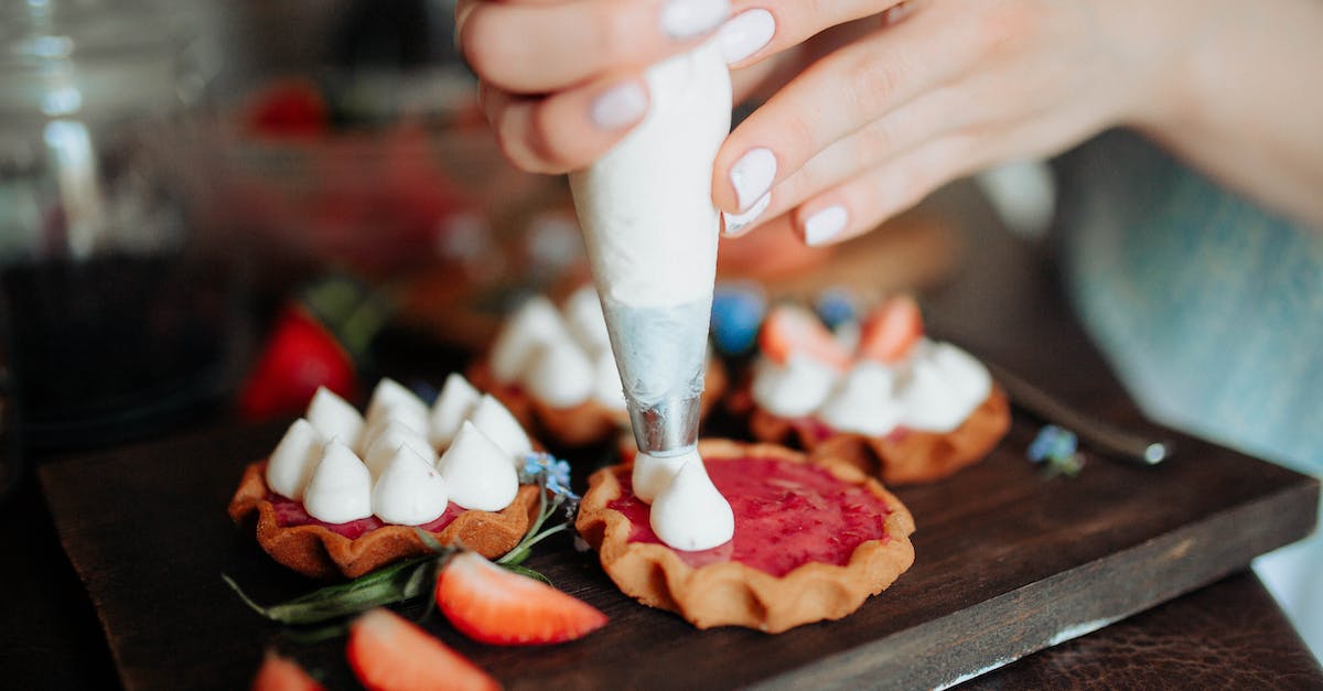 Do Frenzys/cookie multiplyers add to the amount of cookies Wrinklers drop? - Crop anonymous female adding cream on homemade cookies with strawberries placed on wooden board in kitchen in daylight