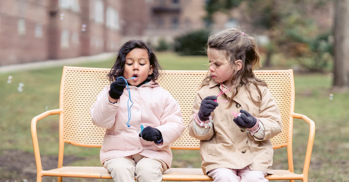 Do goblins activate spring traps? - Cheerful diverse girls blowing bubbles in autumn park