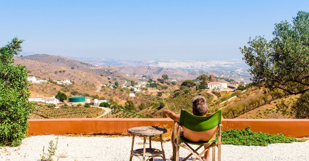 Do higher levels have a larger view distance - Man Sitting on Green Chair Near Trees and Mountain Under Blue Sky at Daytime