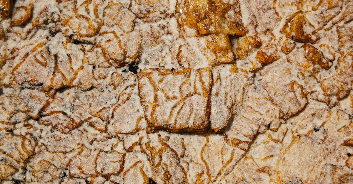 Do I get a refund for parts that land on rails? - Top view of abstract weathered surface of rough rocky formation with uneven texture and relief