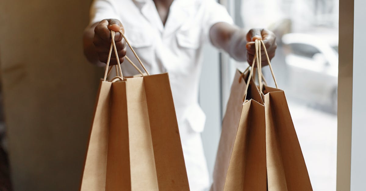 Do I have to give the professor my Pokemon in order to evolve? - Crop anonymous African American person in white jacket passing purchases in paper shopping bags while standing near window in daylight Do I have to give the professor my Pokemon in order to evolve? - Crop anonymous African American person in white jacket passing purchases in paper shopping bags while standing near window in daylight