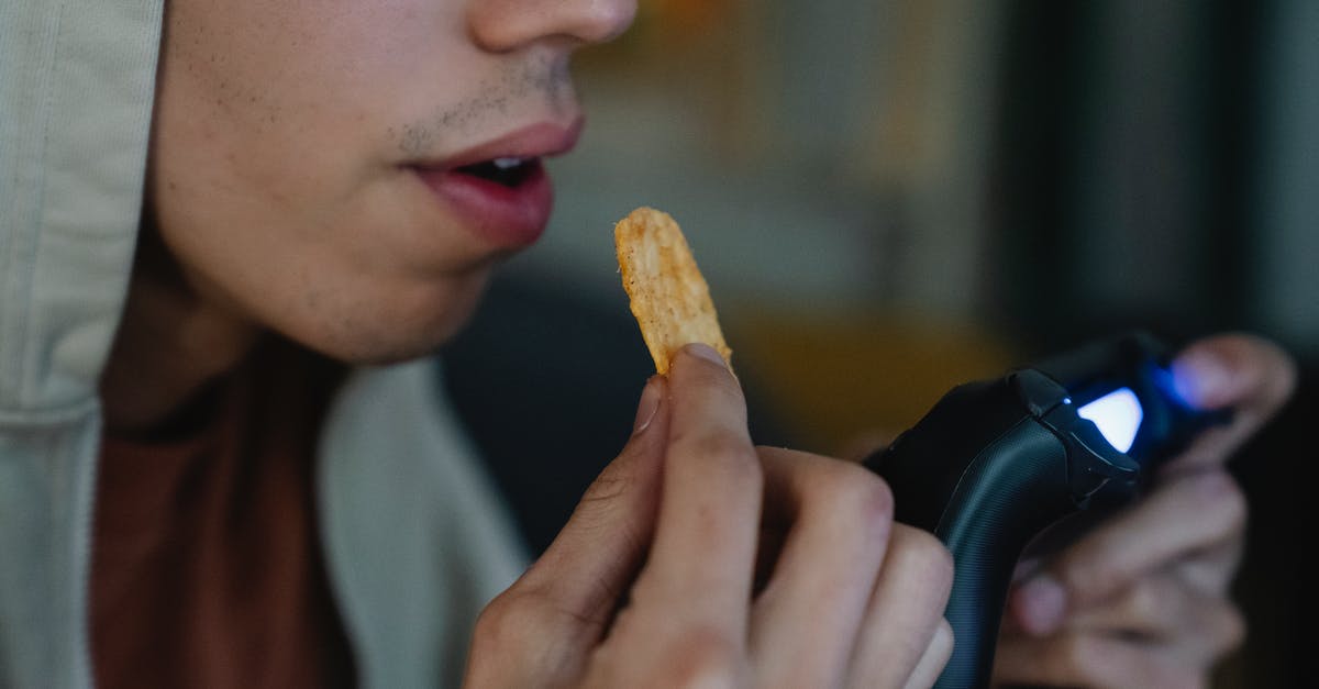 Do I need fast reflexes to play the Telltale game "Game of Thrones"? - Crop gamer with potato chip and gamepad at home Do I need fast reflexes to play the Telltale game "Game of Thrones"? - Crop gamer with potato chip and gamepad at home