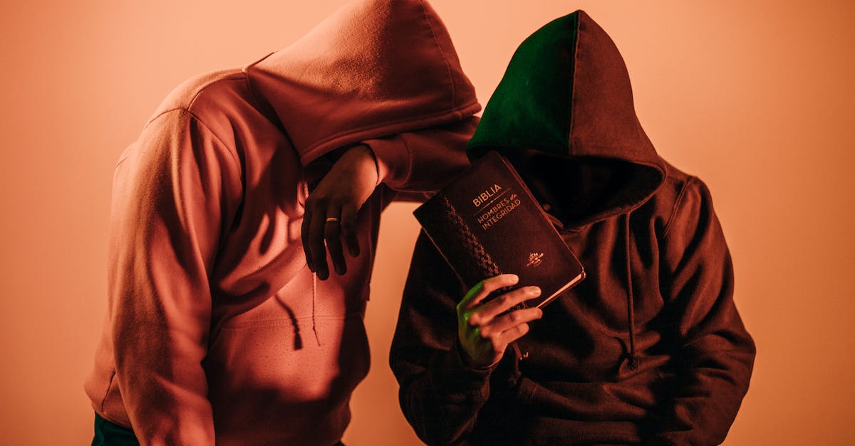 Do Infamy and Holy Mantle synergize together? - Two Person in Pullover Hoodies Holding Book