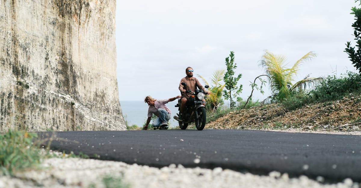 Do kills through Zin's 'Recite' ability grant experience? - Full length male driver of motorbike riding friend in sitting position on skateboard while friend holding seat and touching surface of road with another hand Do kills through Zin's 'Recite' ability grant experience? - Full length male driver of motorbike riding friend in sitting position on skateboard while friend holding seat and touching surface of road with another hand