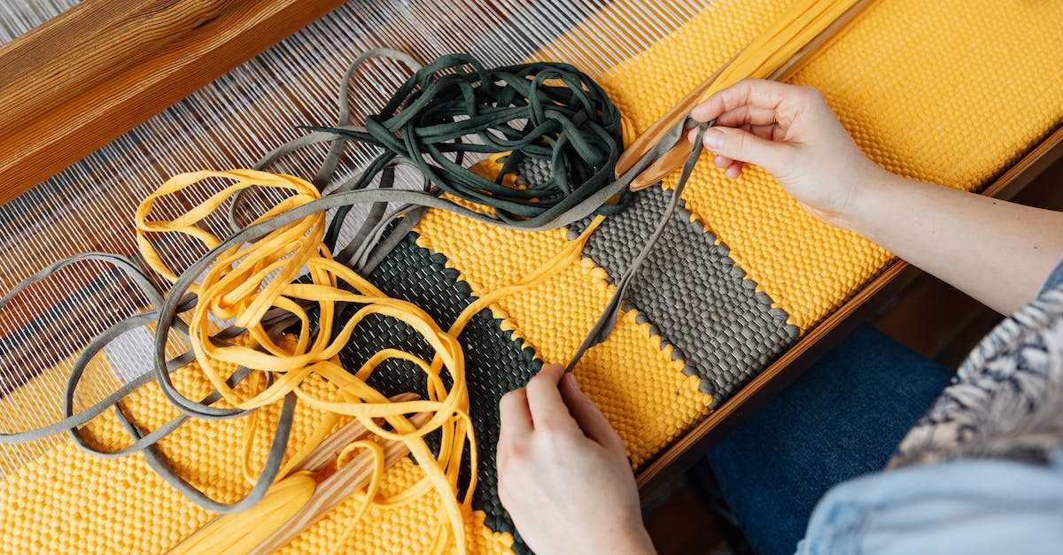 Do large Minecraft servers run on multiple different machines? - Top view of crop anonymous female employee working on wooden weaving loom machine with stretched durable colorful threads in workshop