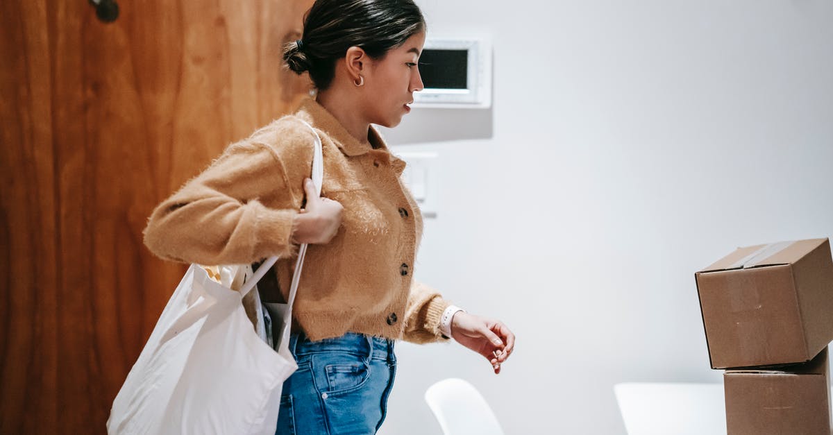 Do logistic drones and vessels carry goods roundtrip? - Focused delivery woman with boxes and shopping bag Do logistic drones and vessels carry goods roundtrip? - Focused delivery woman with boxes and shopping bag