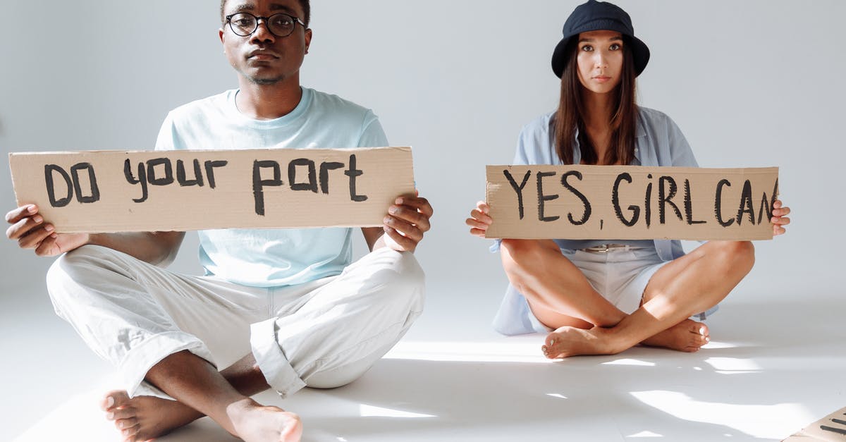Do mirages in your stack gain more experience than those in your lineup? - A Man and a Woman Sitting on Floor Holding Placards