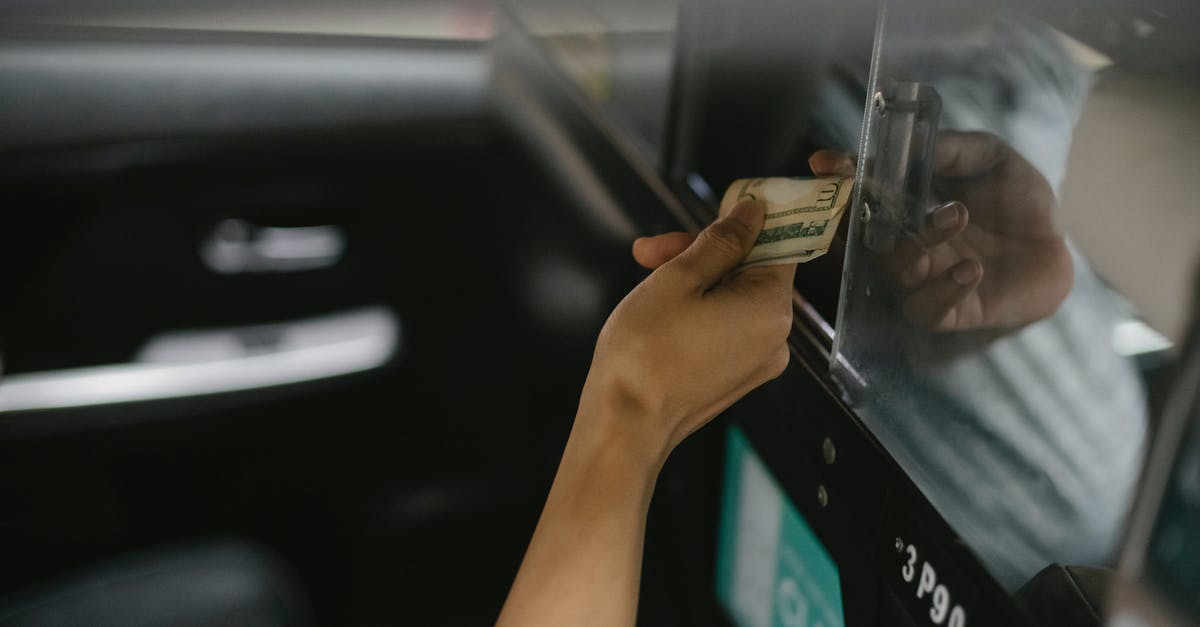 Do monsters give back all money they steal? - Interior of modern taxi car while passenger paying for ride Do monsters give back all money they steal? - Interior of modern taxi car while passenger paying for ride