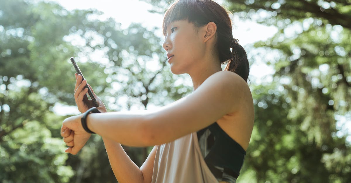 Do more pokemons spawn if your the app is active - Young Asian woman using devices for fitness in park Do more pokemons spawn if your the app is active - Young Asian woman using devices for fitness in park