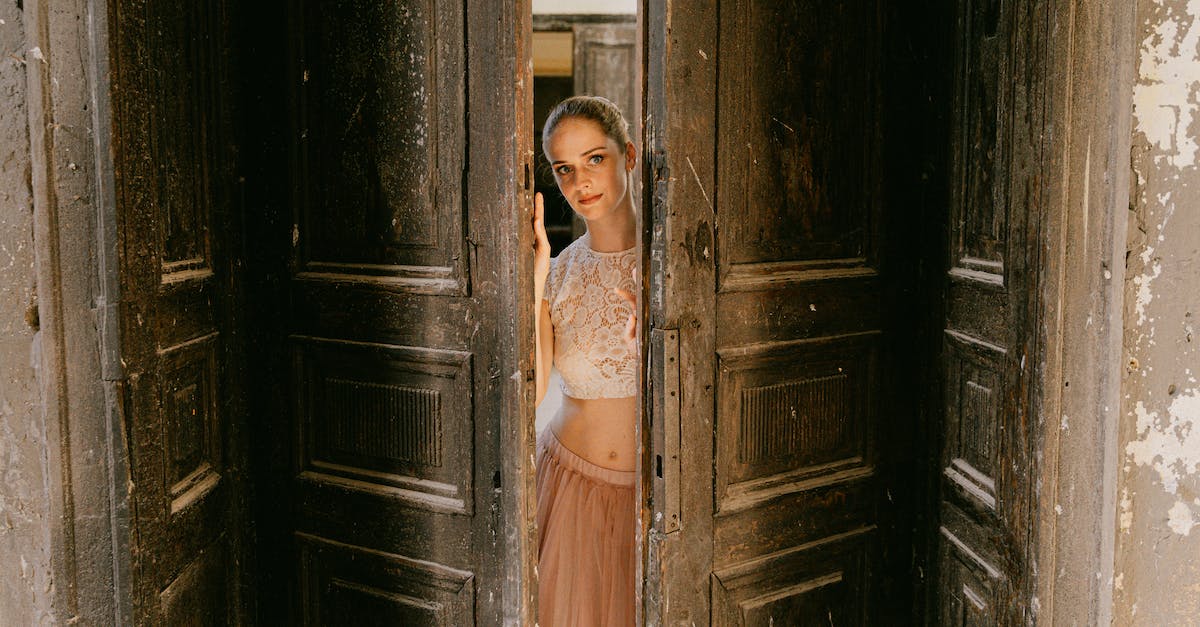 Do mutes persist between games? - A Woman in Lace Top Standing Between the Wooden Door