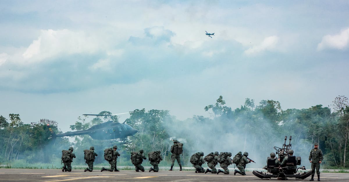 Do my dying soldiers live if I end the mission before stabilizing them? - Unrecognizable soldiers with infantry weapons accomplishing military mission near helicopter