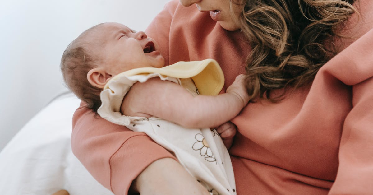 Do my stats on a previous console generation carry over to the next generation via Battlelog? - Side view of crop anonymous mother consoling crying infant baby in arms while sitting in light room near wall at home