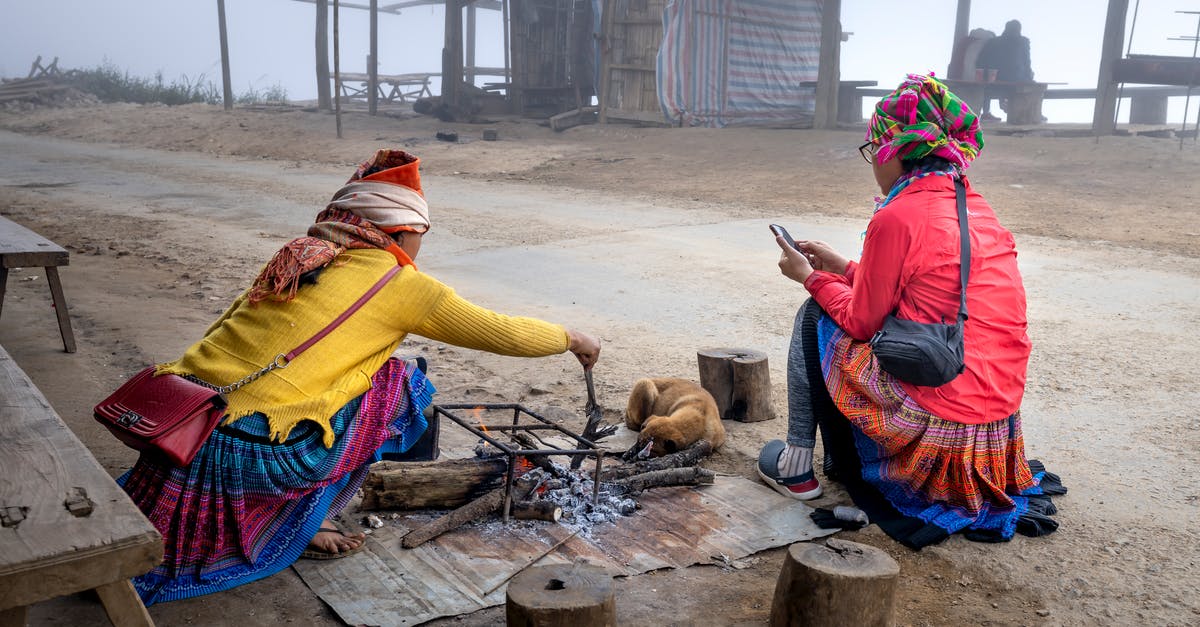 Do non-Kanto Pokemon evolve before getting the National Dex in a randomised Fire Red? - Unrecognizable local women near bonfire in village
