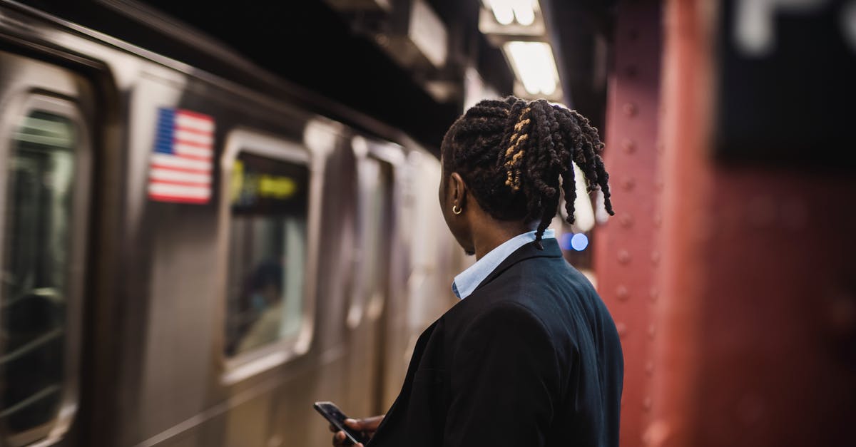 Do office workers like public transport? - Man in suit looking at arriving train on subway Do office workers like public transport? - Man in suit looking at arriving train on subway