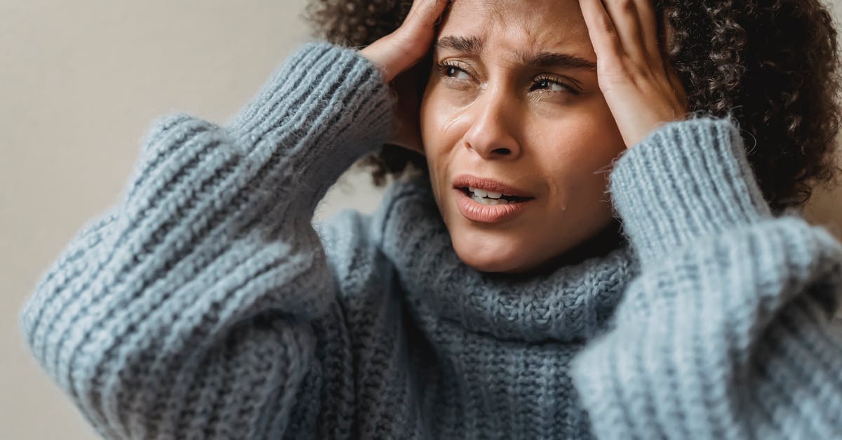 Do other endgame crisis appear if I am already the crisis? - Worried African American female with brown curly hair crying and touching head against light wall