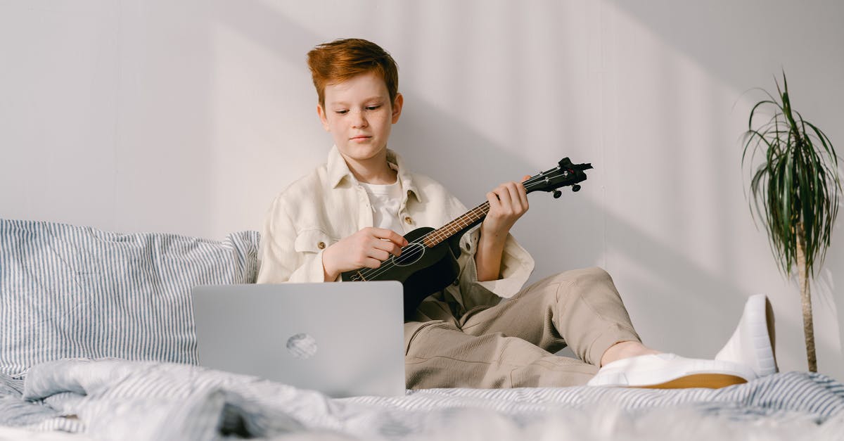 Do people still play the original Counter Strike online on steam? [closed] - A Young Boy Sitting on His Bed while Playing Ukulele