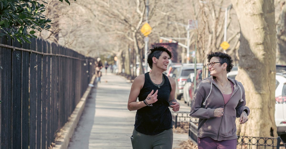 Do players that run into each other share Atlas paths? - Cheerful female friends in activewear looking at each other while jogging on asphalt walkway on street along metal fence in city Do players that run into each other share Atlas paths? - Cheerful female friends in activewear looking at each other while jogging on asphalt walkway on street along metal fence in city