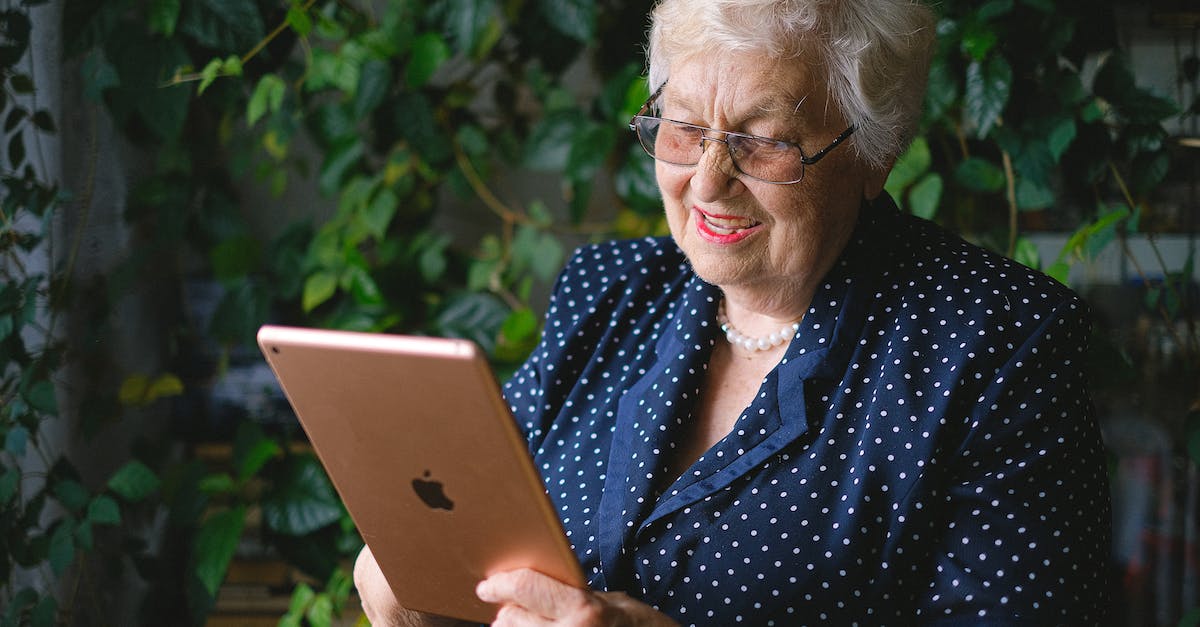Do Pokemon Fire Red/Leaf Green use the new or the old EV/IV calculations? - Aged cheerful female smiling and using contemporary tablet while talking on tablet in living room with green plant