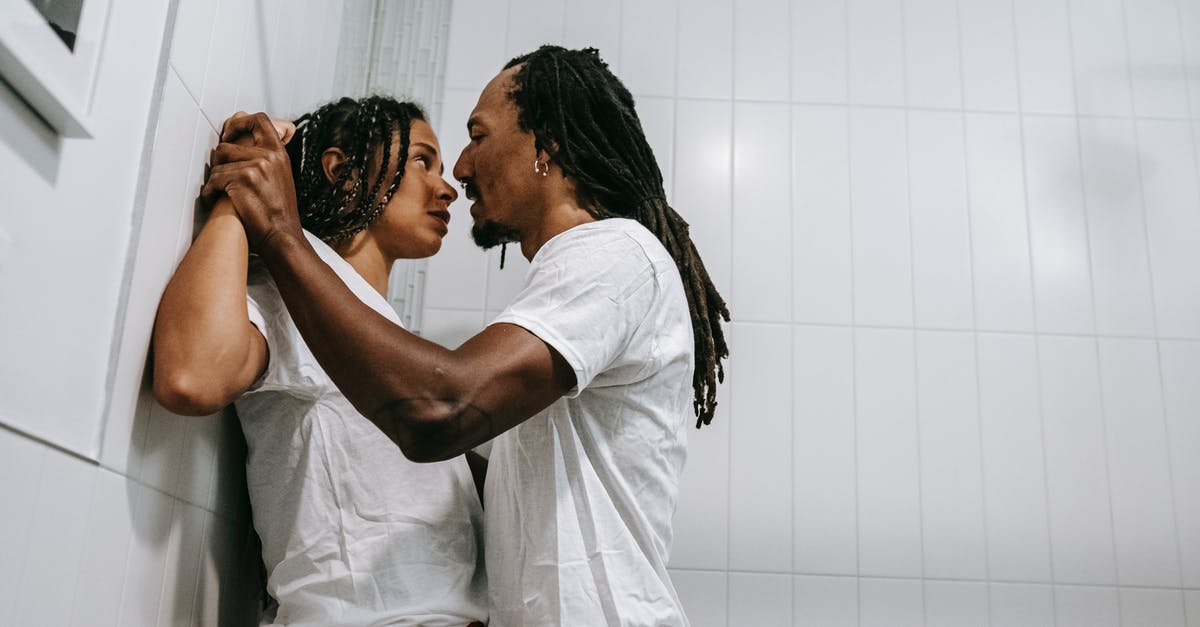 Do Power Troopers revive each other? - Low angle side view of young violent ethnic male with dreadlocks disputing with girlfriend while looking at each other at home