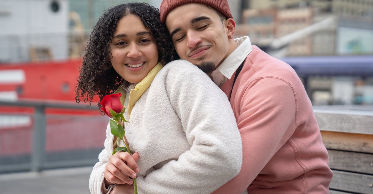 Do Resource Extraction Sites affect anything other than ship spawn rates? - Smiling Latin American couple in warm clothes with red rose cuddling on wooden bench in city street near buildings and ship in daytime