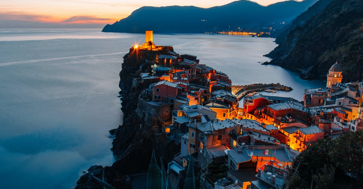 Do settlements even matter? - Amazing landscape of small village with illuminate ancient tower and colorful buildings located on rocky cliff in front of sea in Italy Do settlements even matter? - Amazing landscape of small village with illuminate ancient tower and colorful buildings located on rocky cliff in front of sea in Italy