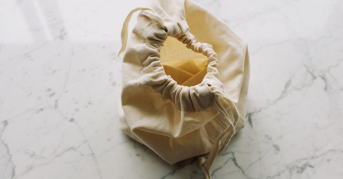 Do skins exterior quality reduce from use? [duplicate] - Top view of empty white fabric sack with drawstrings placed on marble surface in light room