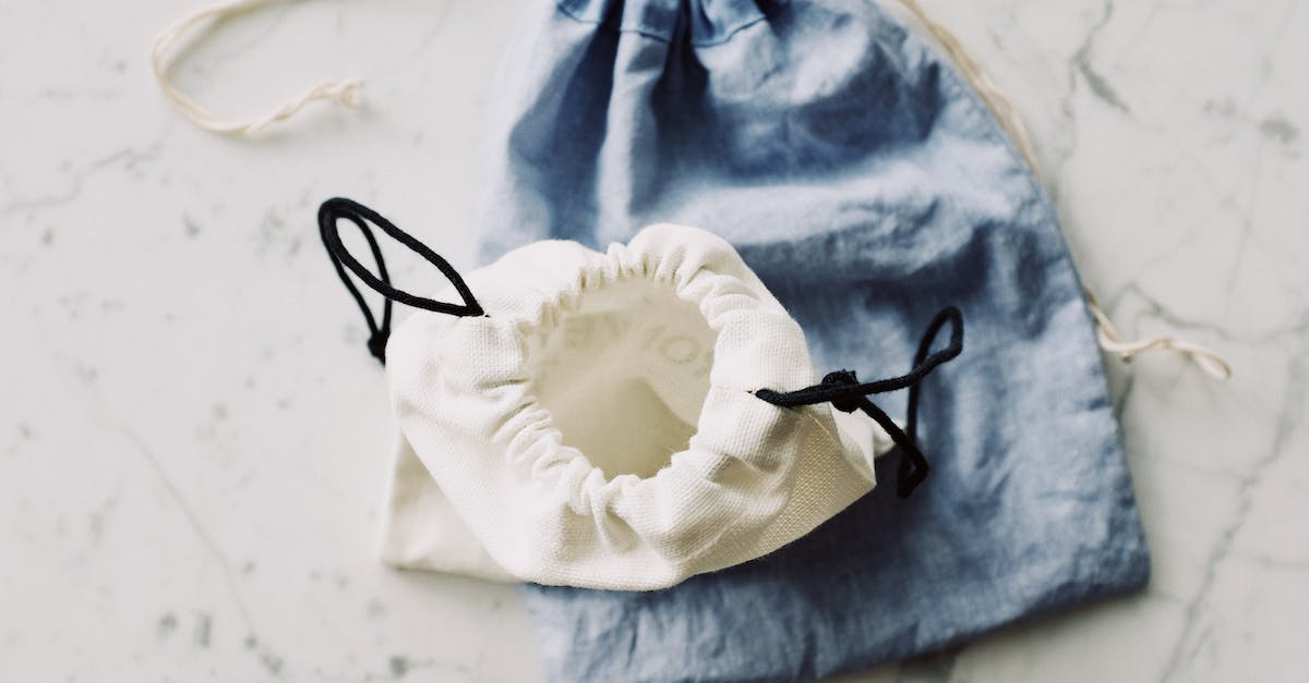 Do skins exterior quality reduce from use? [duplicate] - Top view of composed blue and white modern plain fabric bags on marble table in room