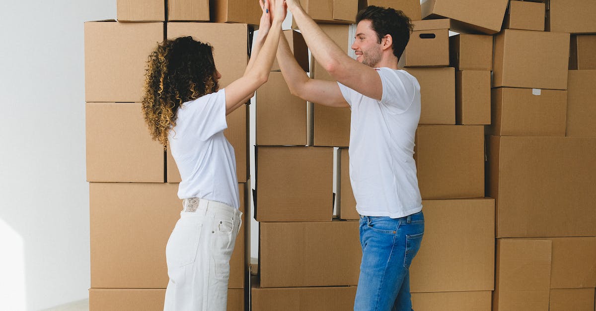 Do spells stack when placed on top of each other? - Smiling couple giving high five after moving into new house