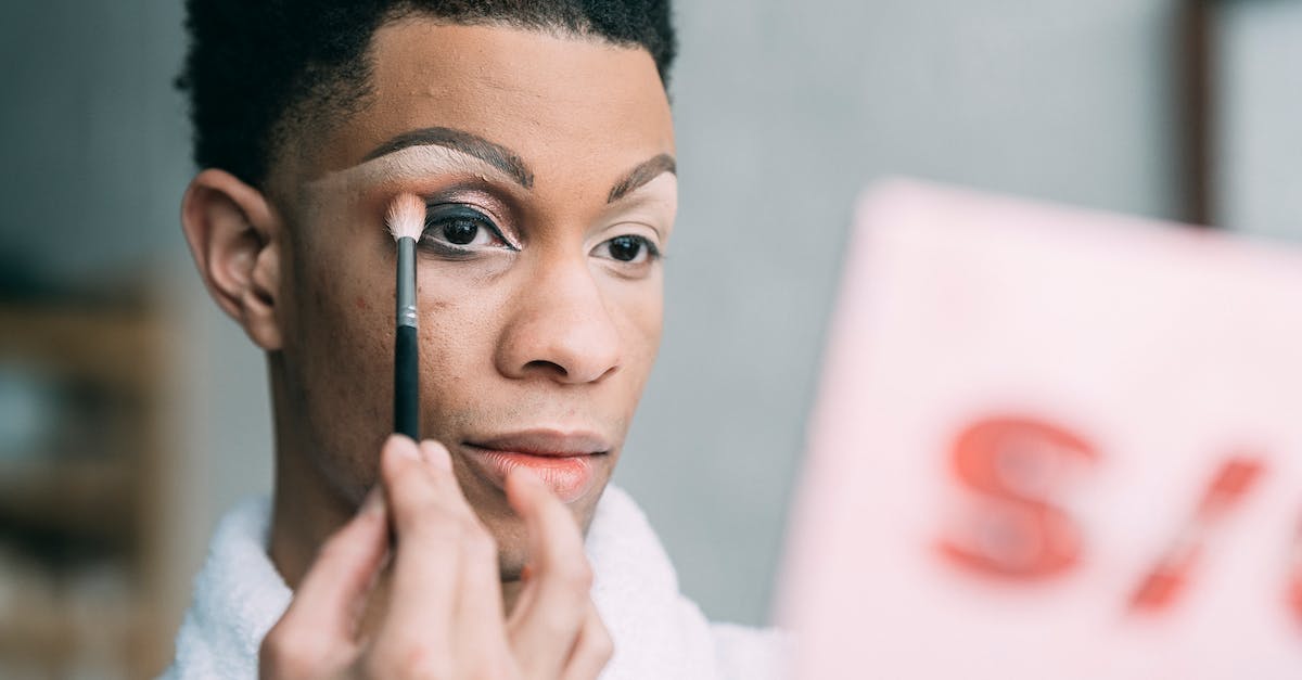Do strange parts apply retroactively? - Feminine black man applying eyeshadow